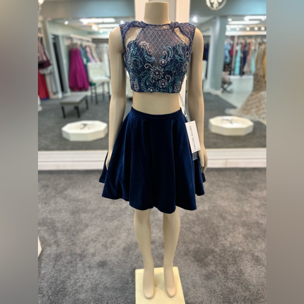 size 4. Navy color. Two piece. Sheer beat it top. Keyhole openings. Open back.